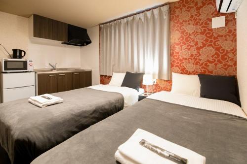 Bright Hotel Kiyomizu - Vacation STAY 71447v في Giommachi: غرفة فندقية بسريرين ومطبخ
