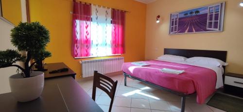 a bedroom with a bed and a table with a table sidx sidx sidx at Complesso turistico Aurora - Appartamenti in Poggio Picenze