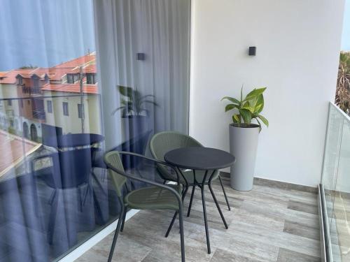 a small black table and chairs in a balcony at DESIGN SUITES Boutique Hotel - Adults Only in Santa Maria