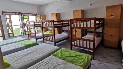 grupa łóżek piętrowych w pokoju w obiekcie Hostal Tah Itza w mieście Flores