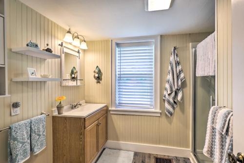 a bathroom with a sink and a mirror and a shower at Finger Lakes Farm Retreat Walk to Wineries! in Hector
