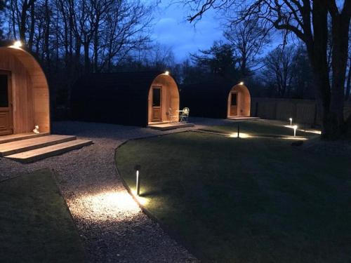 a yard lit up at night with lights at Wilding on a Whim in West Linton