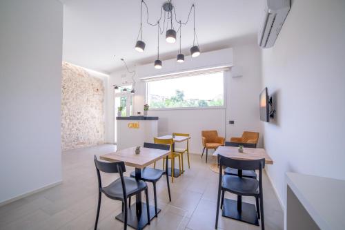 un restaurante con mesas y sillas y una ventana en Ciuri' Affittacamere, en Alcamo