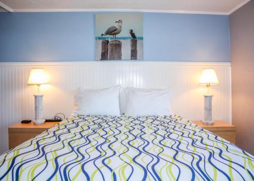 a bedroom with a bed and a lamp at River Wilderness Waterfront Cabins in Everglades City