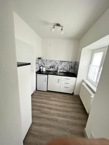 a kitchen with white cabinets and a counter top at Penzion Rozárka in Přísečná