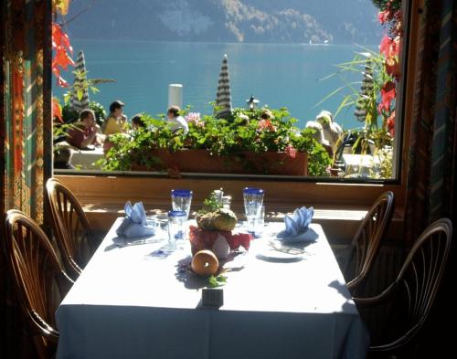 a table in a restaurant with a view of the ocean at Seehotel Bären in Brienz
