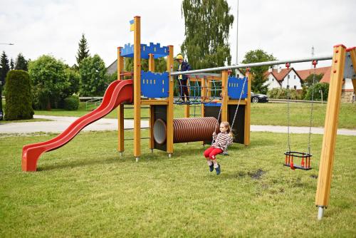 a little girl playing on a playground at Penzion Rozárka in Přísečná