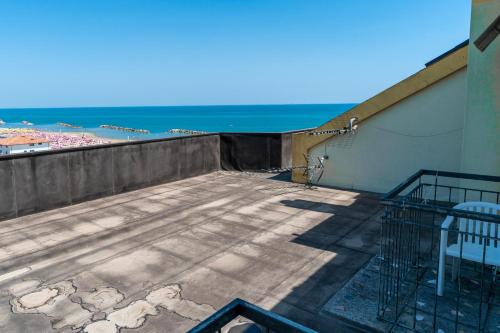 a balcony with a view of the ocean at Hotel Montmartre in Rimini