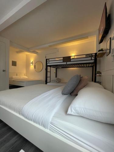 a bedroom with a large white bed in a room at Hotel and the City, Rooftop City View in New York