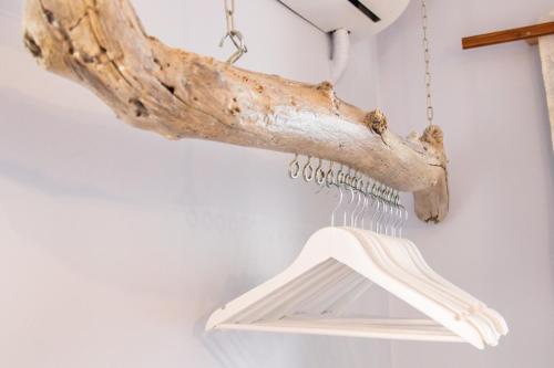 a branch chandelier hanging from a wall at Gorgona Blue Apartments in Karpathos Town