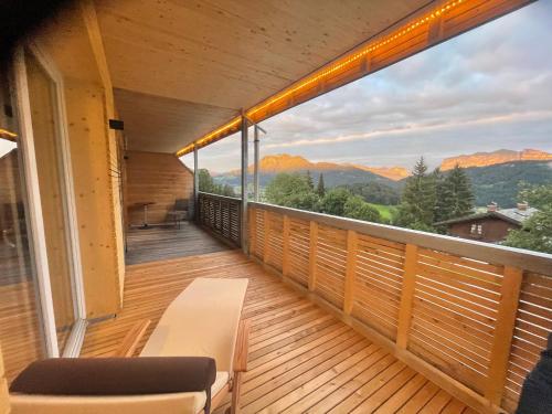 a balcony with a view of the mountains at Panoramahotel Sonnhalde in Schwarzenberg im Bregenzerwald