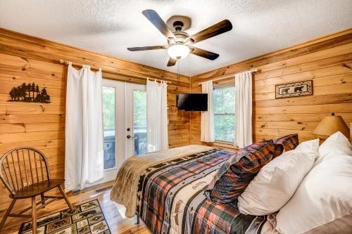 a bedroom with a bed and a ceiling fan at Lazy Bear Cabin in Epworth