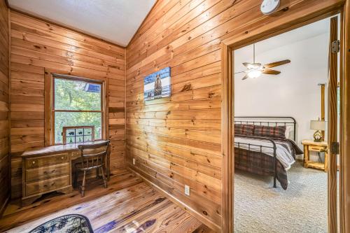 a log cabin bedroom with a desk and a bed at Lazy Bear Cabin in Epworth
