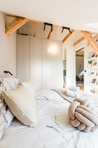 a bedroom with a white bed with towels on it at Apartament nad jeziorem Drwęckim Turystyczna # 17 in Ostróda