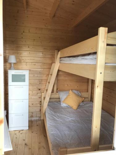 a bedroom with bunk beds in a wooden cabin at Sosnowy Zakątek Stegna- domki letniskowe in Stegna