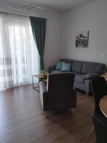a living room with a couch and a table at Apartman, studio and room Kata in Pula