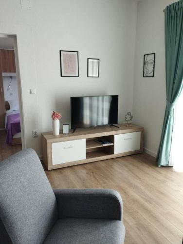 a living room with a tv and a couch at Apartman, studio and room Kata in Pula