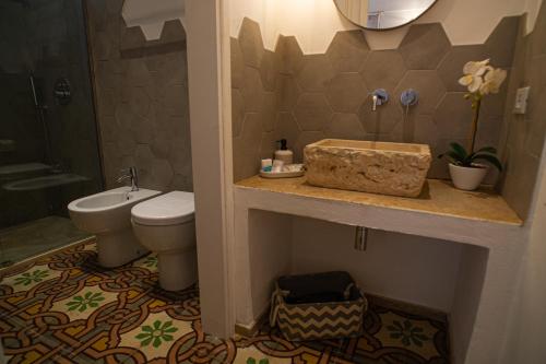 a bathroom with a sink and a toilet at meridiano12 in Favignana