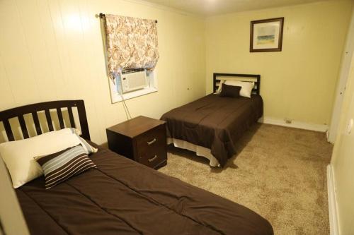 1 Schlafzimmer mit 2 Betten und einem Fenster in der Unterkunft 3-Bedroom apt. ideal location near new river gorge in Fayetteville