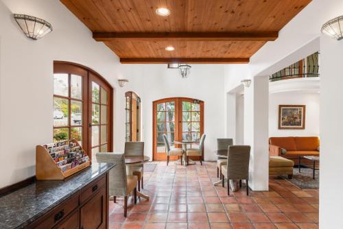 a living room with a table and chairs at Inn by the Harbor in Santa Barbara