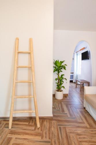 a ladder leaning against a wall in a living room at Gorgona Blue Apartments in Karpathos Town