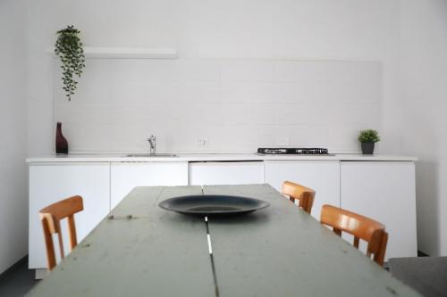 a kitchen with a table with a plate on it at Casa Lupita in Favara