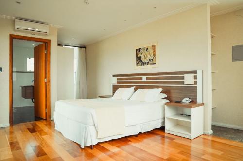 Postel nebo postele na pokoji v ubytování Hotel Imperial de Quatro Barras