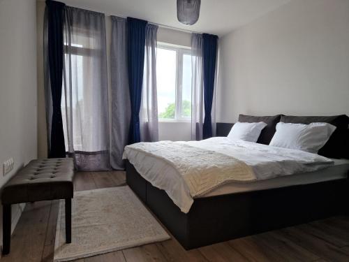a bedroom with a large bed and a window at Apartment Enya in Burgas