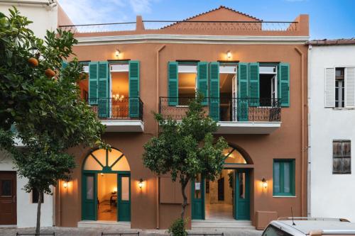 a house with green shutters and a balcony at Nobili Boutique Hotel in Chania Town