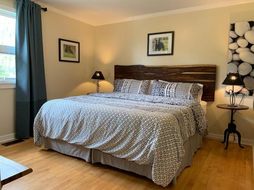a bedroom with a large bed and two lamps at Canadian Rockies Inn - Adults only in Field
