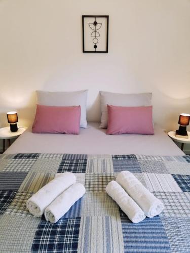 a bed with two towels and two pillows on it at Apartman Aria in Dugi Rat