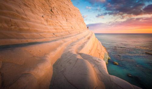 a view of a large eroded rock in the ocean at Casa Lupita in Favara