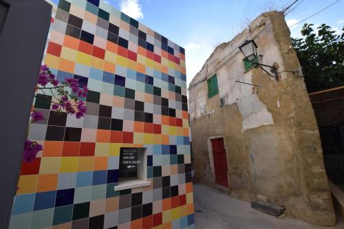a colorful tiled wall next to a building at Casa Lupita in Favara