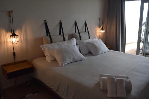 a bedroom with a white bed with two towels on it at Tradewinds Apartments Simpson Bay in Simpson Bay