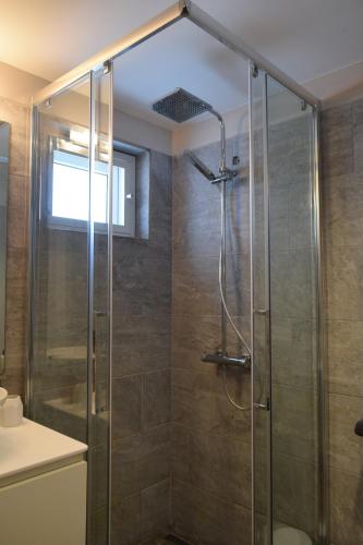 a shower with a glass door in a bathroom at Tradewinds Apartments Simpson Bay in Simpson Bay