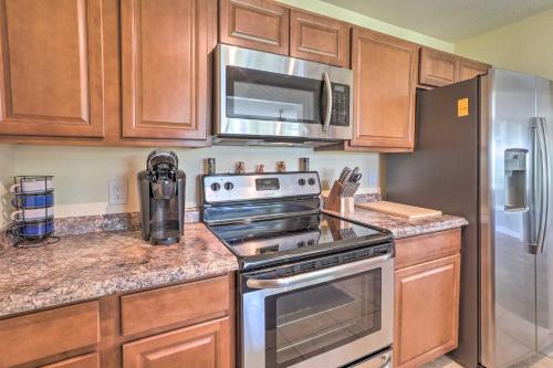 a kitchen with a stove and a microwave at Deltona Lake House, Day Trip to Disney and Universal in Deltona