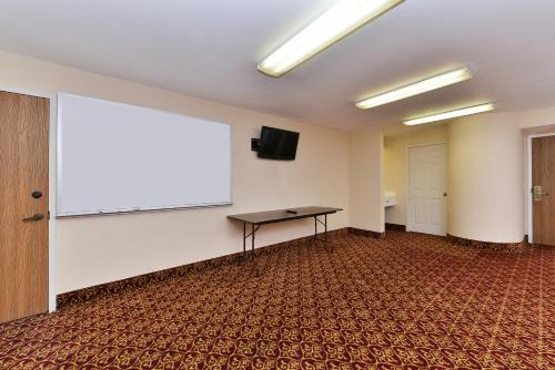 a large projection screen in a room with a table at America's Best Value Inn & Suites, Atlanta - Morrow in Morrow