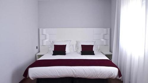1 dormitorio con 1 cama grande y 2 almohadas en Hotel Pepo, en Benifallet