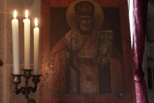 a painting of a pope with two white candles at Domaine du Très-Haut - Château de Montanges in Montanges