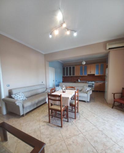 a living room with a table and a couch at Arjana & Nelaj Apartments in Ksamil