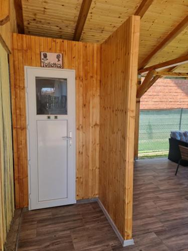 a room with a white door in a wooden wall at Holiday Home in Velika Mlaka