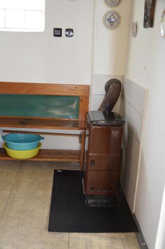 an old stove in a corner of a room at Chata u Hřiště in Loučeň