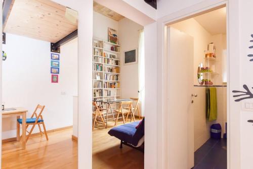 two views of a living room and dining room from the hallway at 8 Studio in Rome