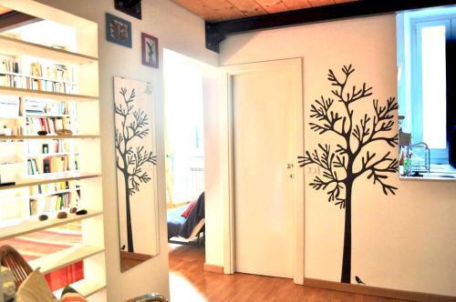 a hallway with a tree stenciled on the wall at 8 Studio in Rome