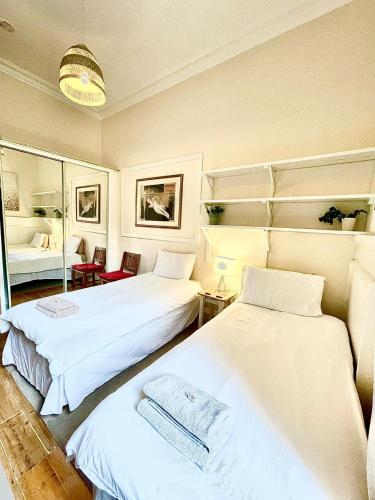a room with two beds and a mirror at Central Edinburgh - Large groups in Edinburgh