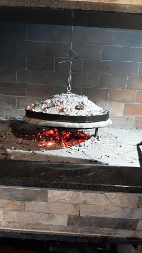 a pizza is cooking in a brick oven at Apartmani Adi&Ena in Konjic