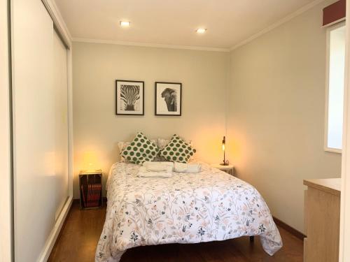 a bedroom with a bed and two pillows on it at Happy Ria House in Gafanha da Nazaré