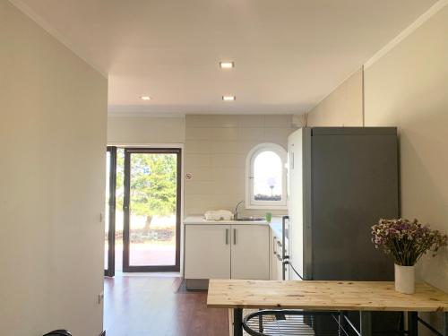 a kitchen with a counter and a table in it at Happy Ria House in Gafanha da Nazaré