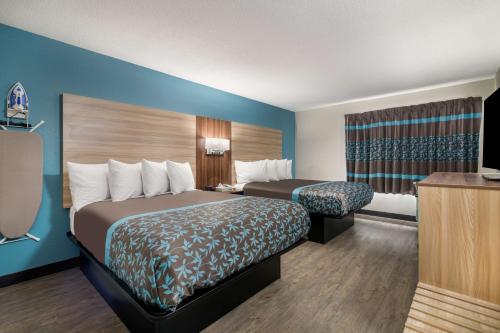 a hotel room with two beds and a television at SureStay Hotel by Best Western Lewiston in Lewiston
