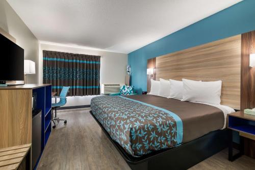 a hotel room with a large bed and a desk at SureStay Hotel by Best Western Lewiston in Lewiston